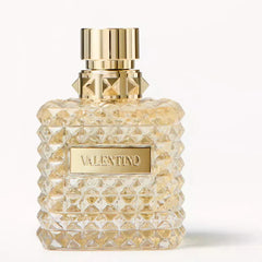 Valentino perfume bottle with gold cap and label on a white background