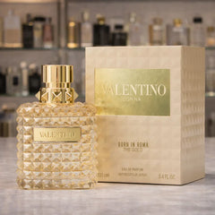 Valentino perfume bottle and packaging on a wooden surface with blurred background
