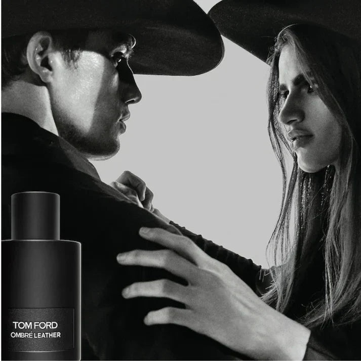 Black and white image of a couple embracing with a Tom Ford Ombré Leather bottle.