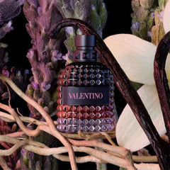 Valentino perfume bottle with decorative elements on a dark background
