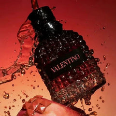 Valentino perfume bottle with water splashes on a red background