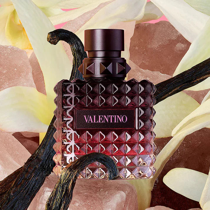 Valentino perfume bottle with geometric design on a colorful abstract background
