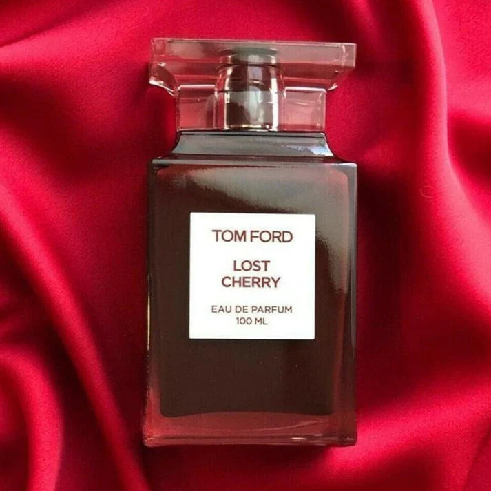 Tom Ford Lost Cherry perfume bottle on a red fabric background