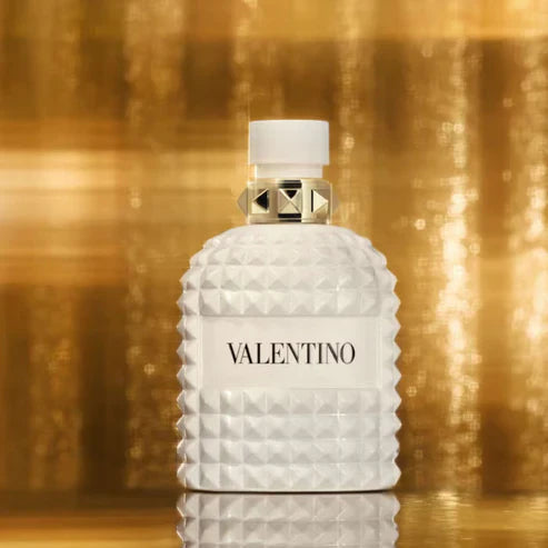 Valentino perfume bottle on a gold background