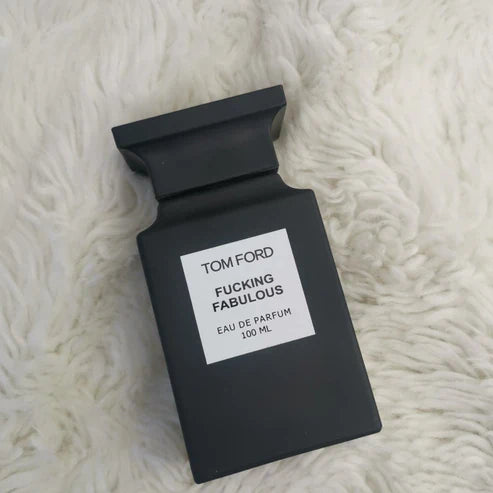 Black Tom Ford perfume bottle labeled 'Fucking Fabulous' on a white fur background