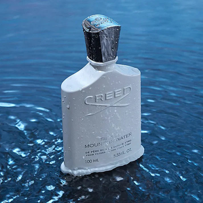 Creed perfume bottle on water