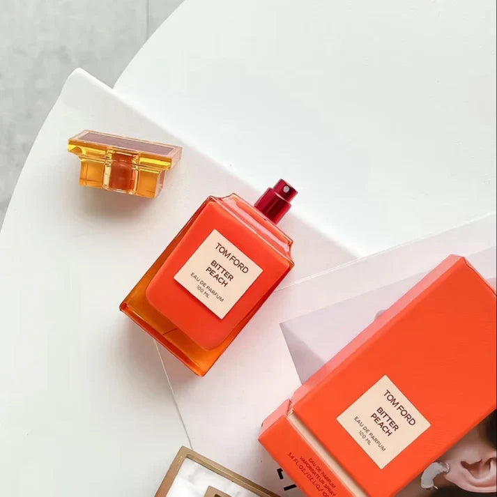 Tom Ford perfume bottles with packaging on a light background